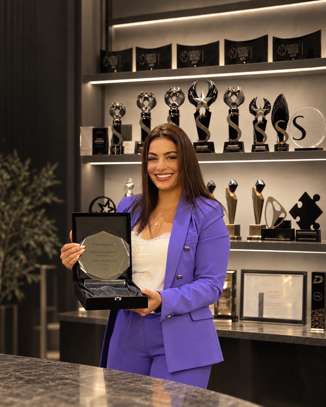 Alice holding a Highest Achiever award