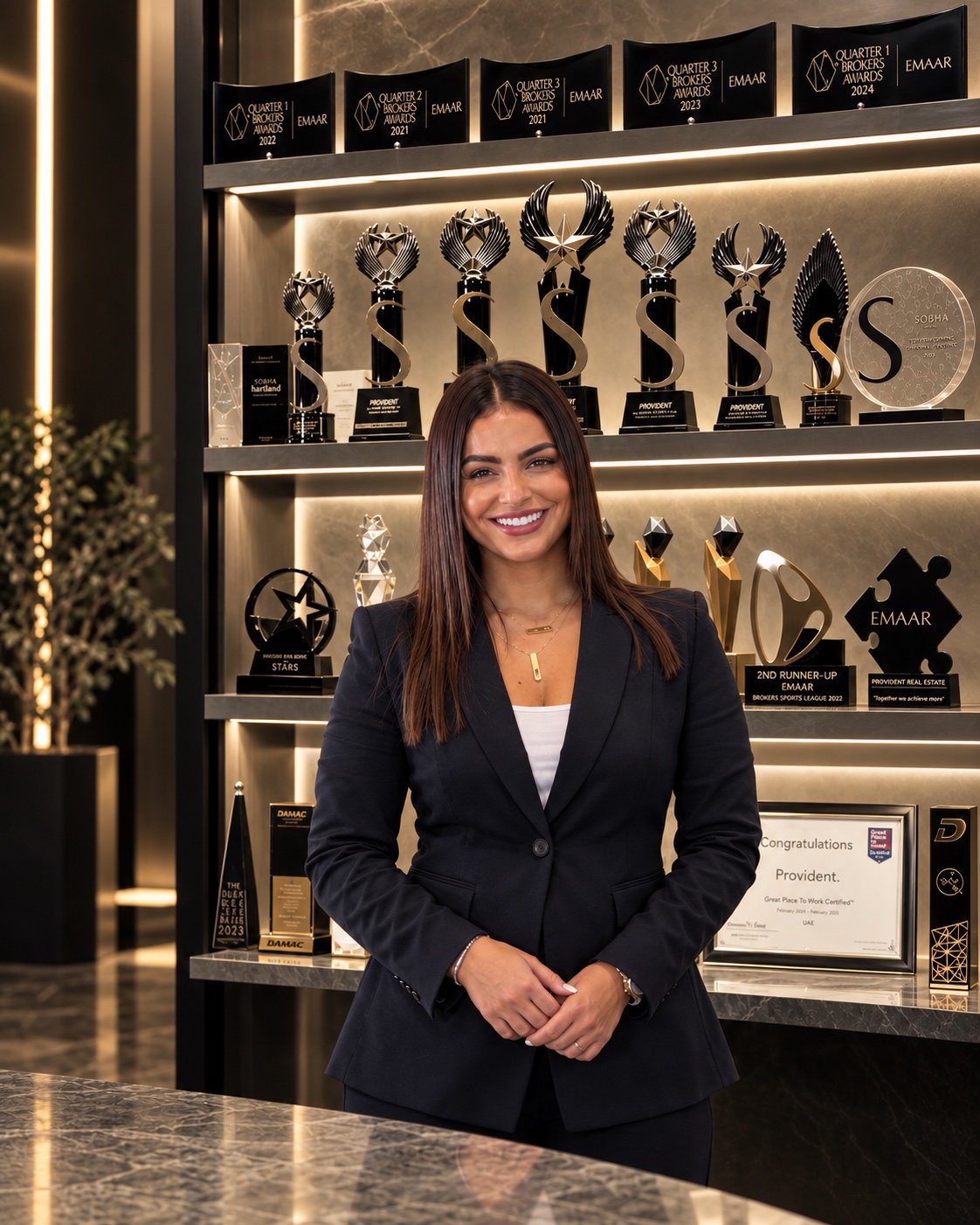 Alice standing in front of a display of industry awards