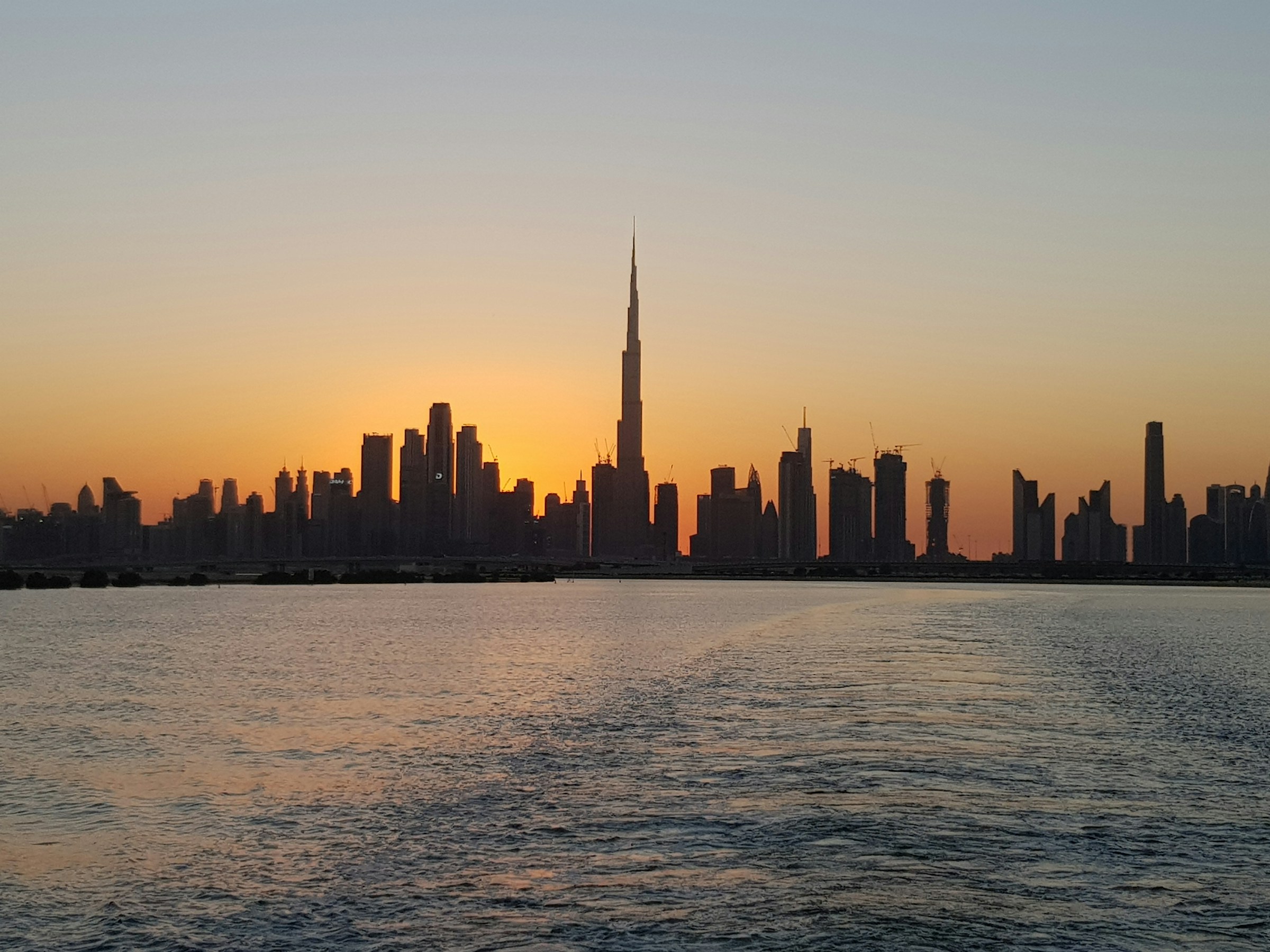 Dubai waterfront and skyline at sunset
